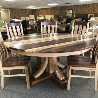 A wooden table and chairs are sitting in a room.