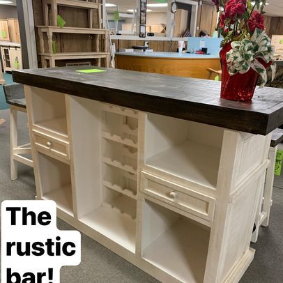 A rustic bar with a wine rack on top of it