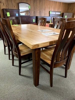 A wooden table and chairs are sitting in a room.
