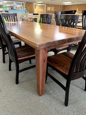 A wooden table and chairs are sitting in a room.