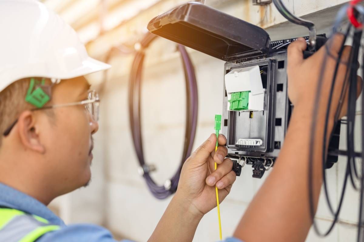 A professional cable technician working on preparing and testing cable connections for a client at Walker Electric near Lexington, KY