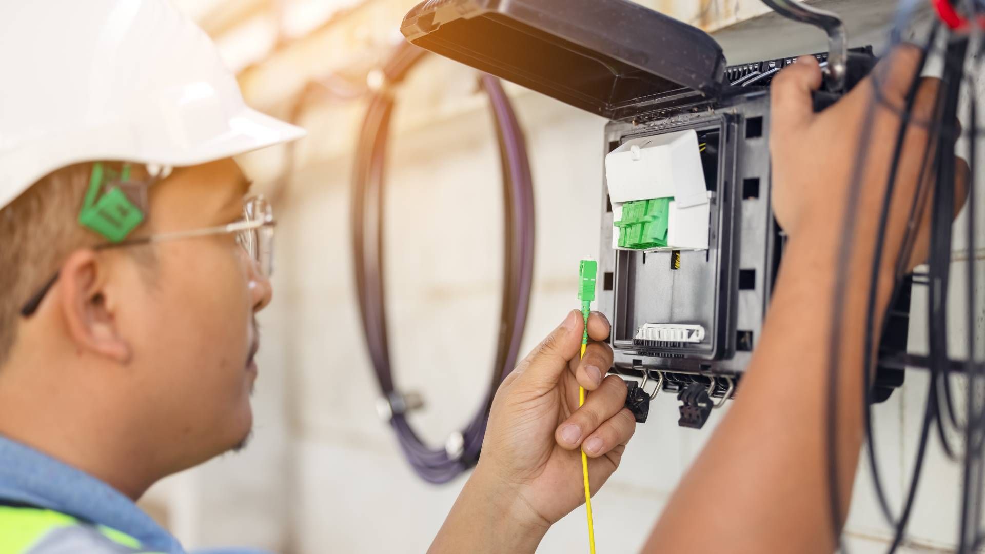 A professional cable technician working on preparing and testing cable connections for a client at W