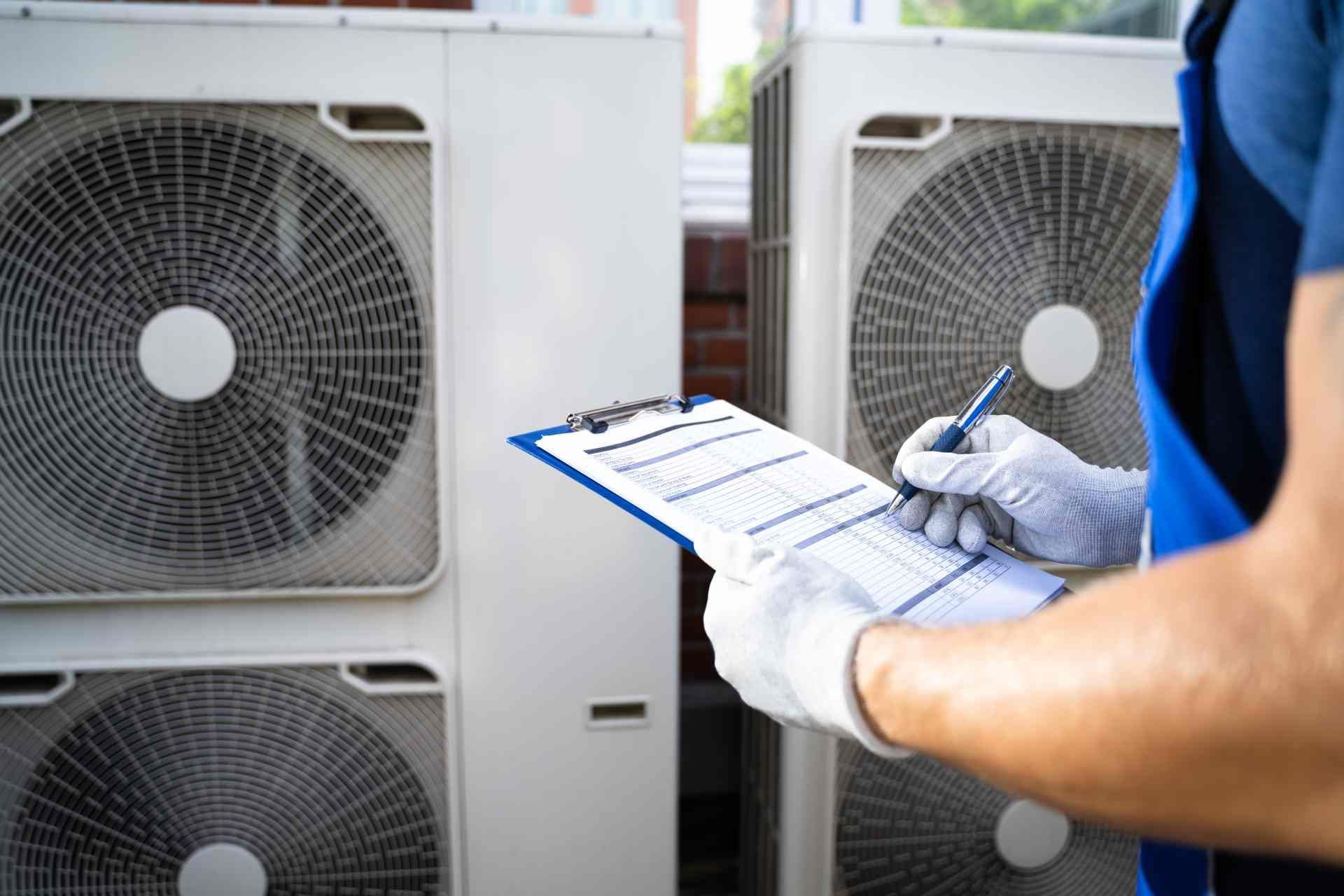 Commercial electrician with a blue clipboard inspecting a business for electrical issues and post-ho