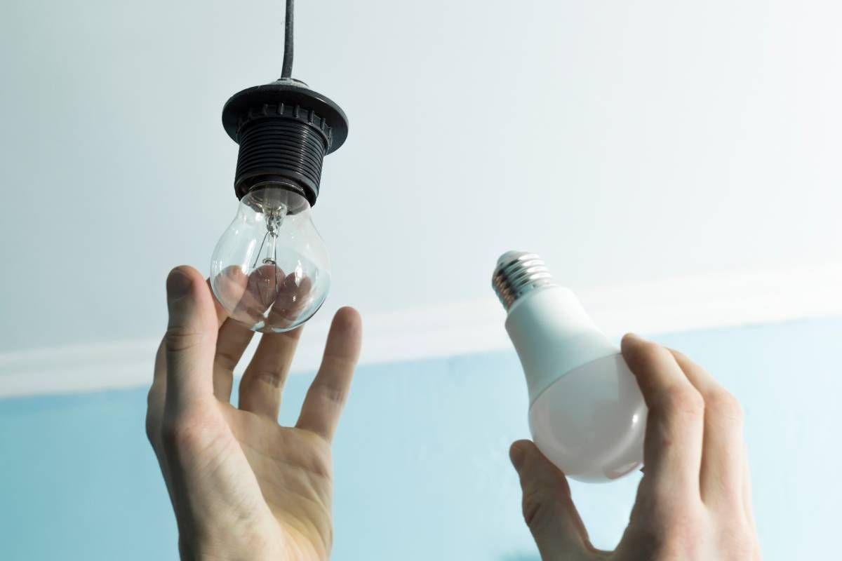 An incandescent lightbulb being replaced with an LED bulb near Lexington, KY