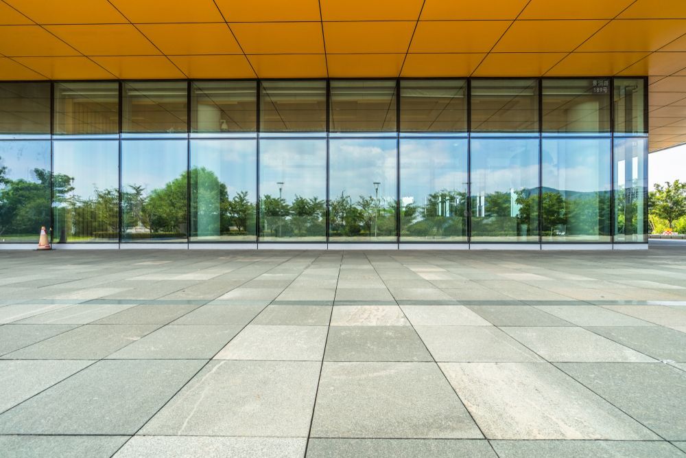 A Large Building with A Lot of Windows and A Tiled Floor in Front of It — NQ Trading In Edmonton, QLD