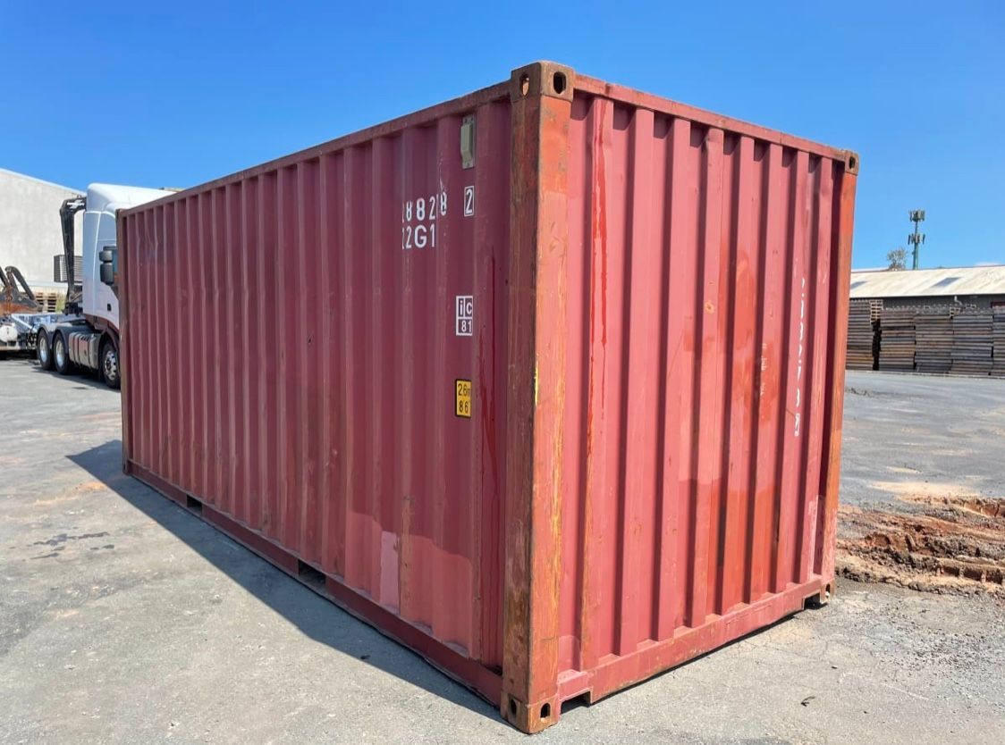 A Red Shipping Container Is Parked in A Parking Lot Next to A Truck — NQ Trading In Edmonton, QLD