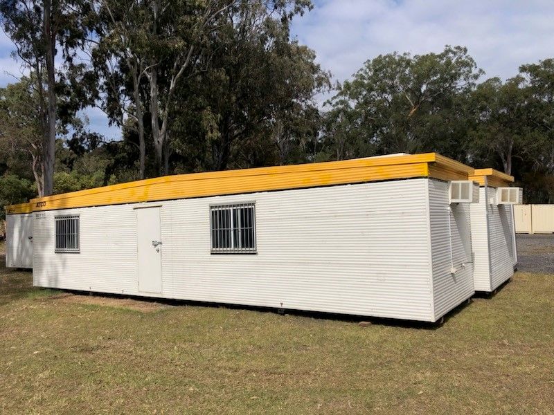 A Relocatable Yellow And White Building Sitting In A Parking Lot — NQ Trading In Edmonton, QLD