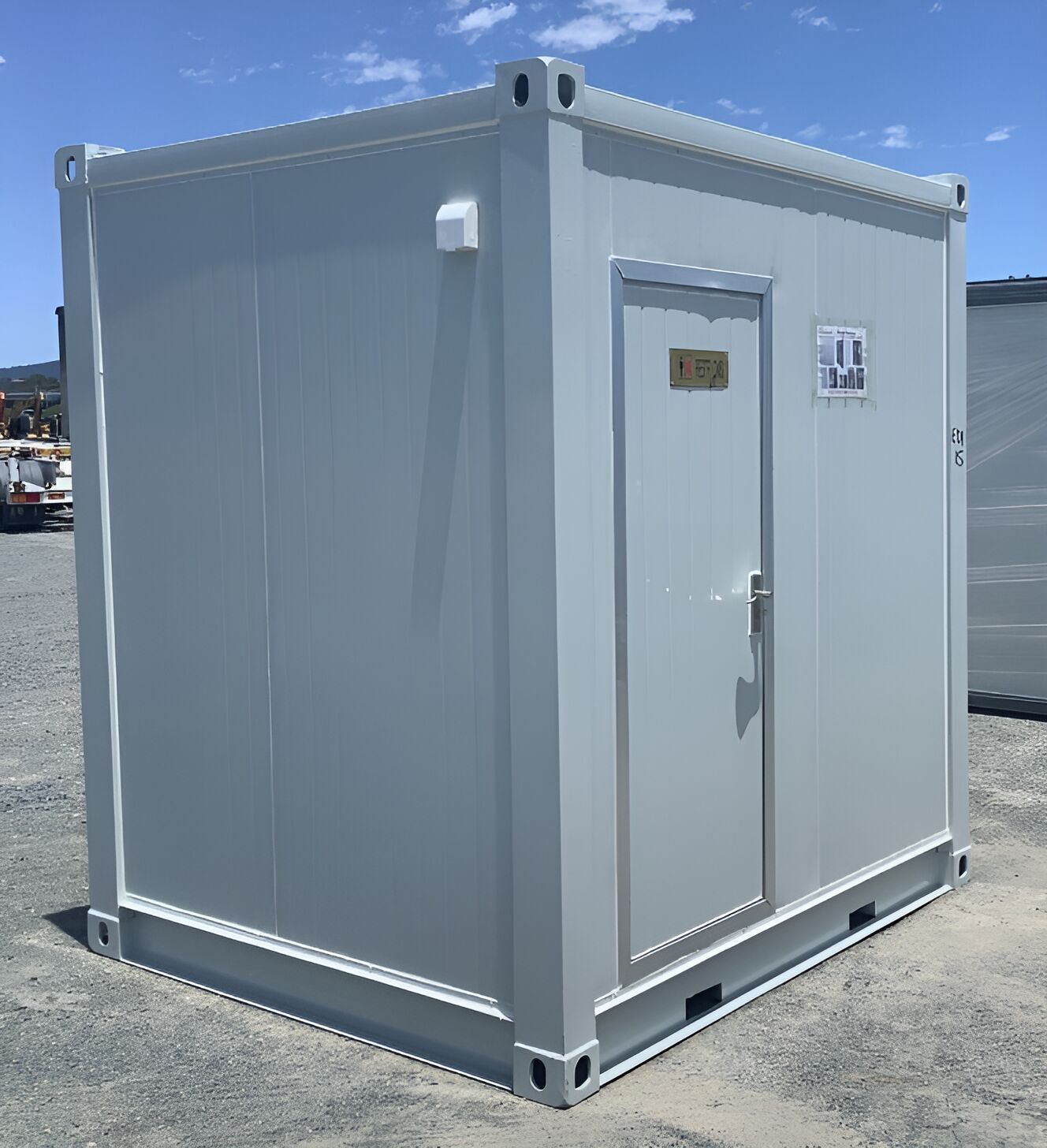 A Small White Building With A Door And A Sign On It — NQ Trading In Edmonton, QLD