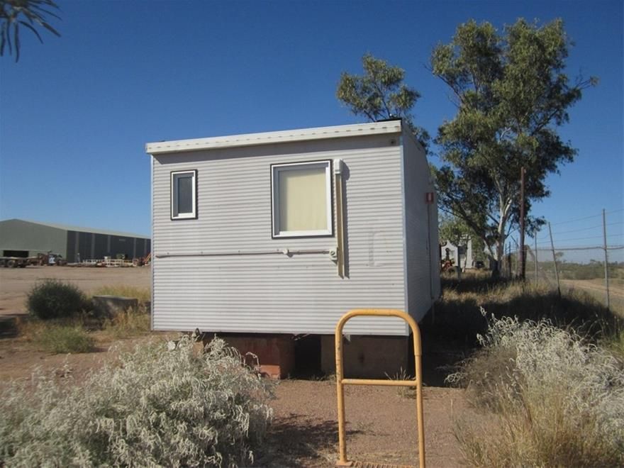 A Small White House With a Window and a Yellow Railing — NQ Trading in Brisbane, QLD