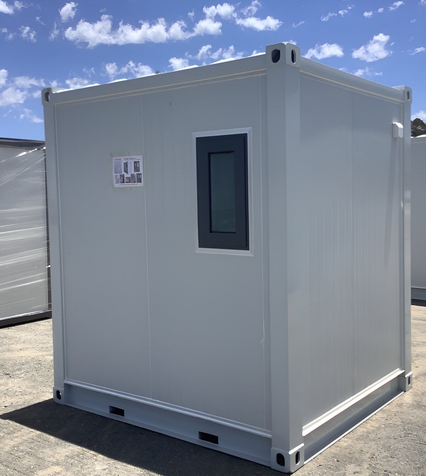 A White Container With A Window On The Side Is Sitting In A Parking Lot — NQ Trading In Edmonton, QLD