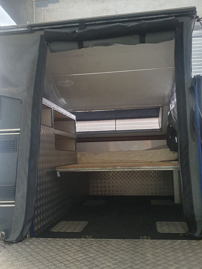 A Tent is Sitting Inside of a Vehicle With the Door Open — NQ Trading in Brisbane, QLD