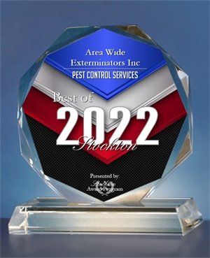 A clear trophy awarded to Area Wide Exterminators Inc. for