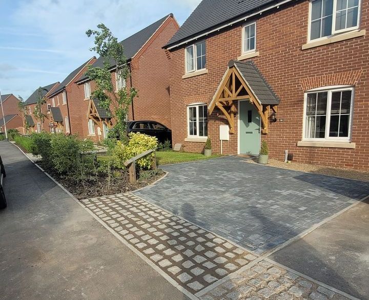 A row of brick houses with a car parked in front of them.