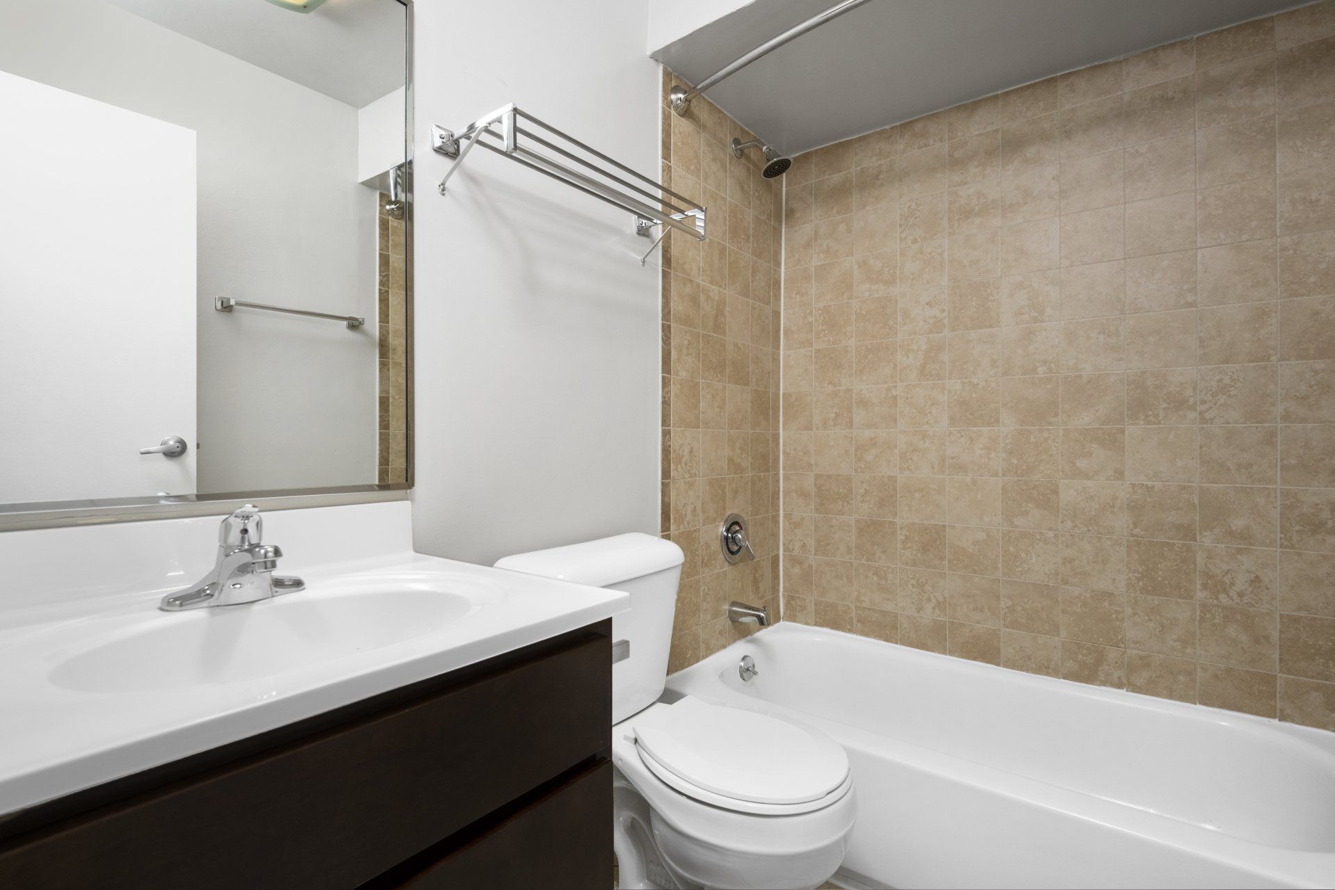 A bathroom with a toilet, sink, and bathtub at Reside 707 in Lakeview, Chicago.