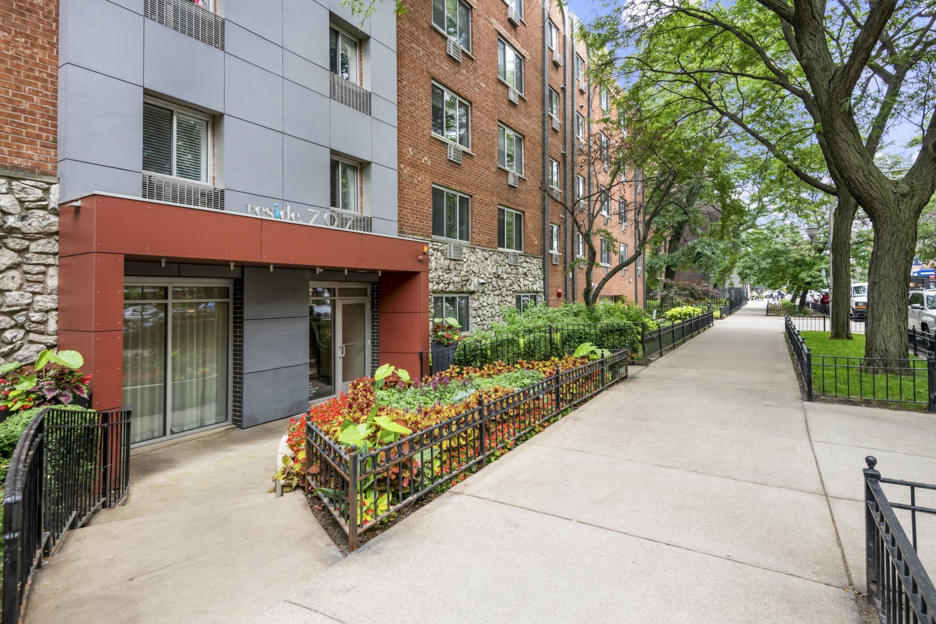 Reside 707 apartment building with a walkway leading to it.