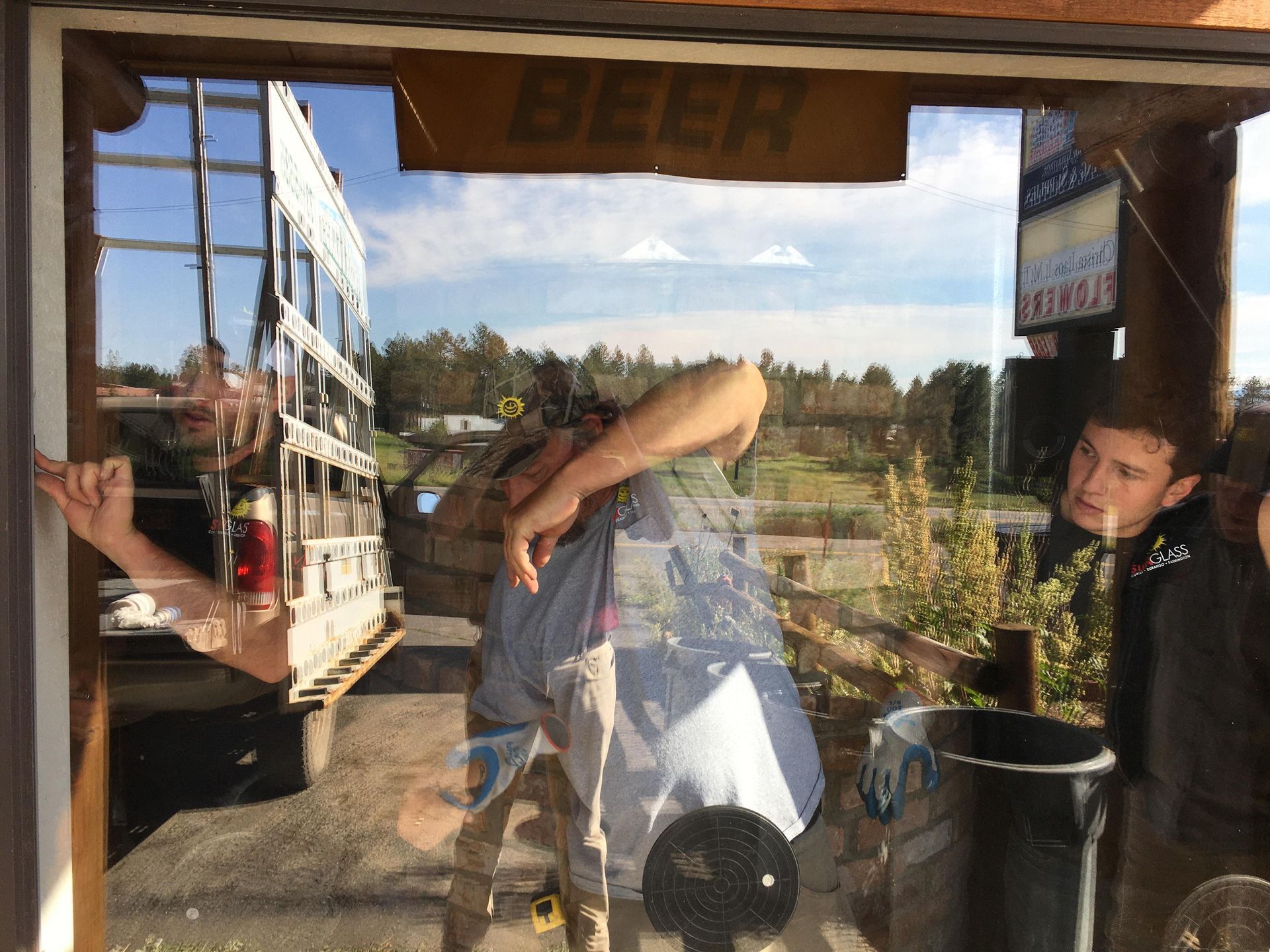 a statue of Sunny of Sunglass being installed on top of a building