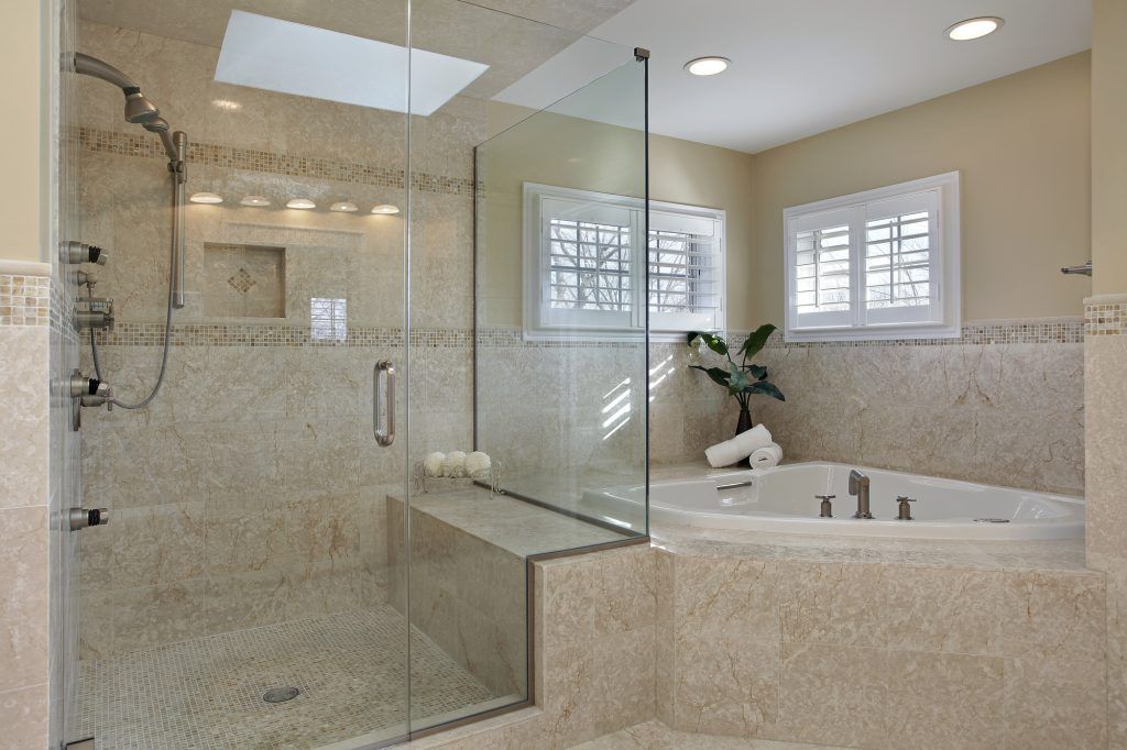a bathroom with a tub and a walk in shower, shower glass is from Sunglass