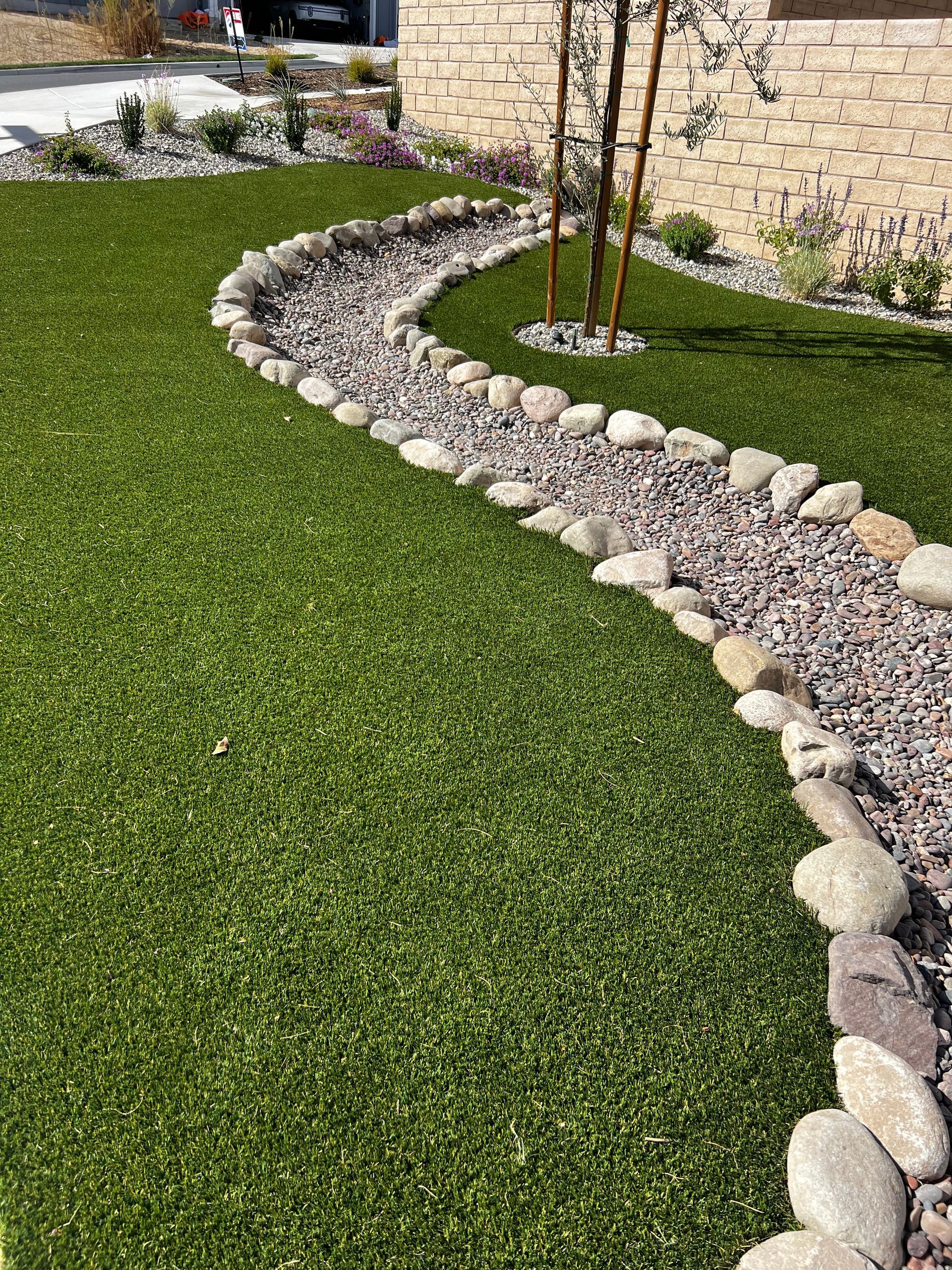 There is a path going through the grass and rocks.