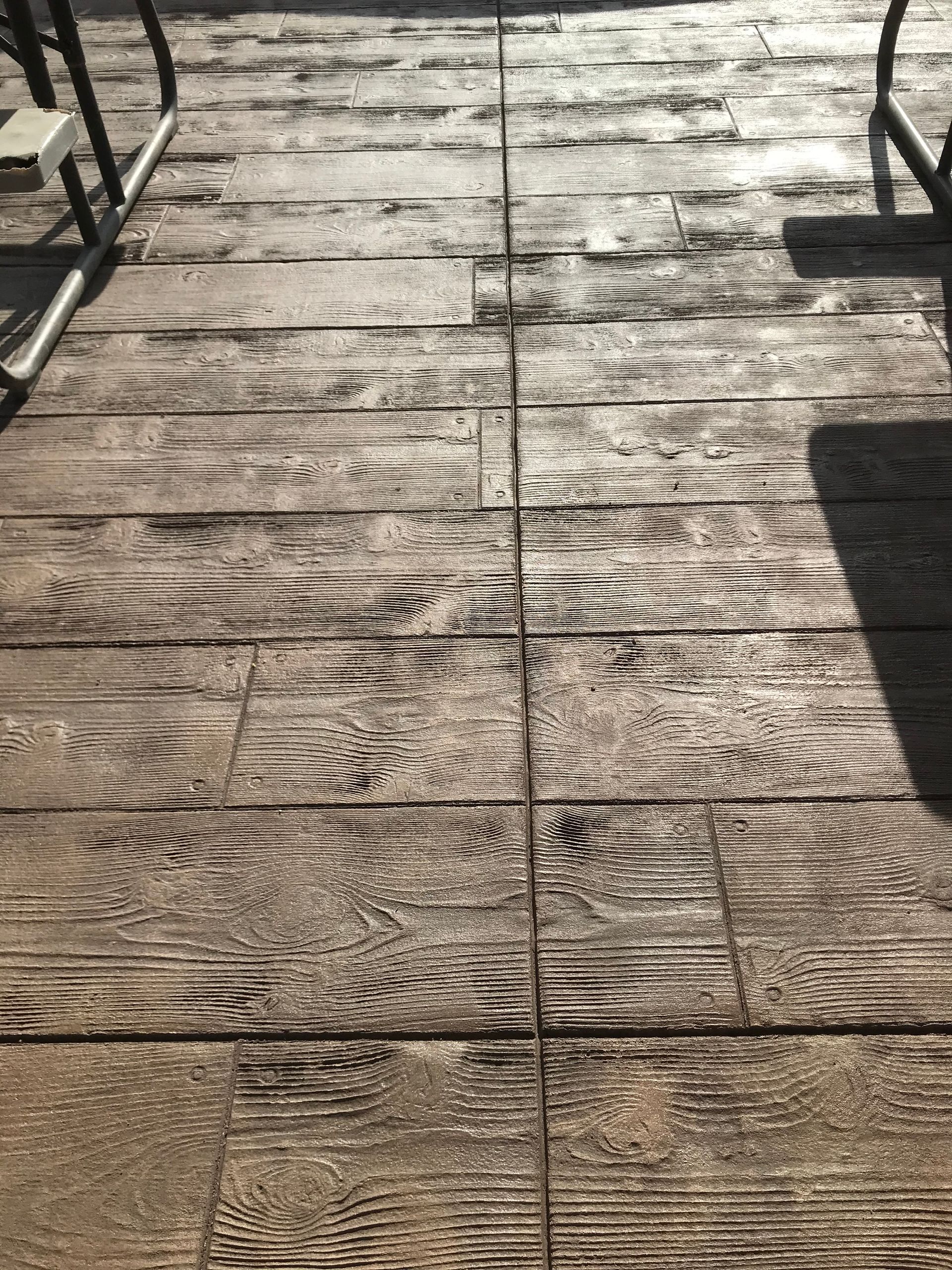 A close up of a concrete floor that looks like wood.