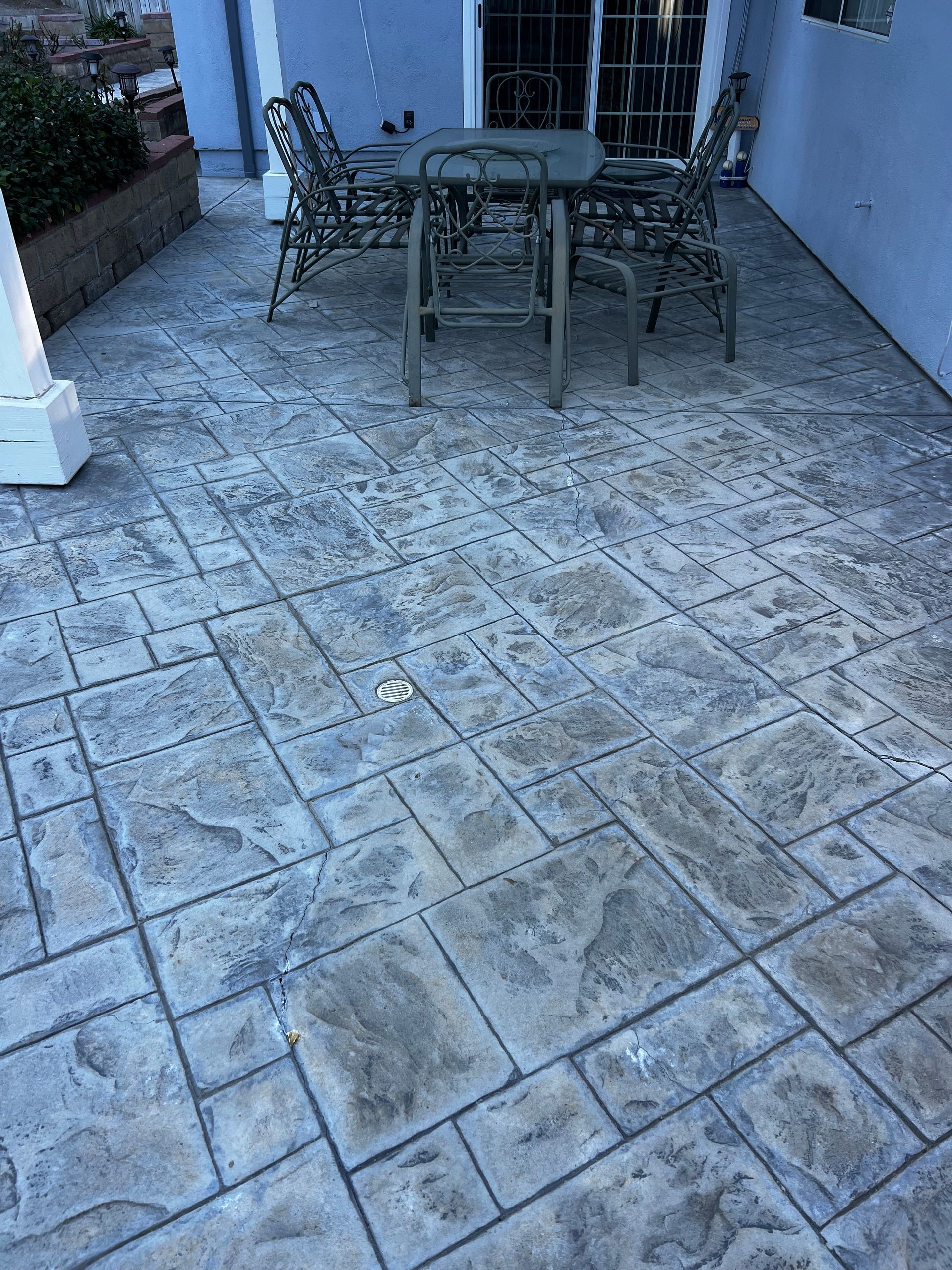 A patio with a table and chairs on it.