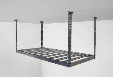 A metal shelf is hanging from the ceiling of a garage.