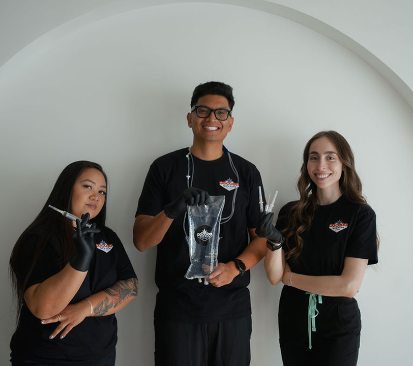 A man and two women standing next to each other holding scissors