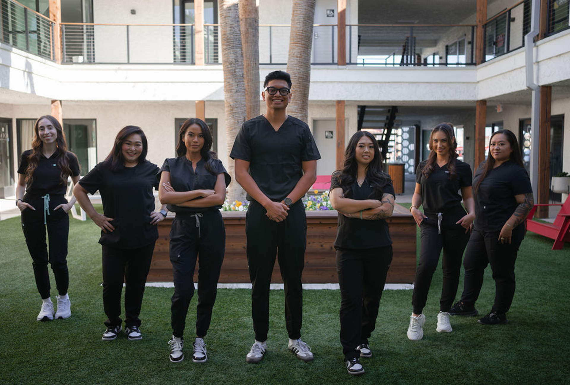 A group of people in scrubs are posing for a picture.