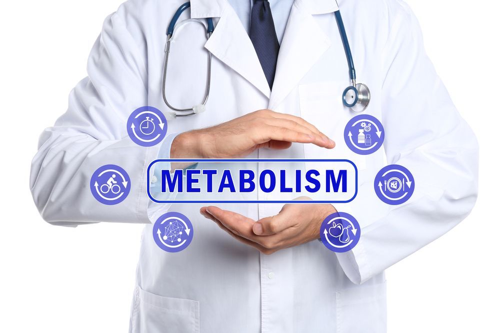 A doctor is holding a sign that says metabolism in his hands.