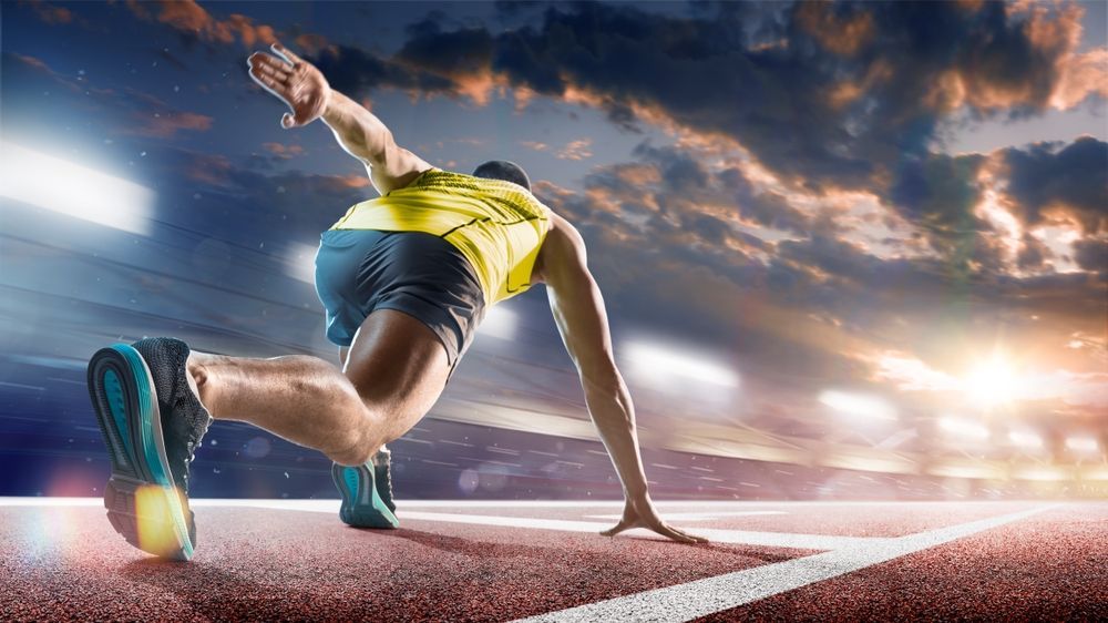 A man is getting ready to run on a track.