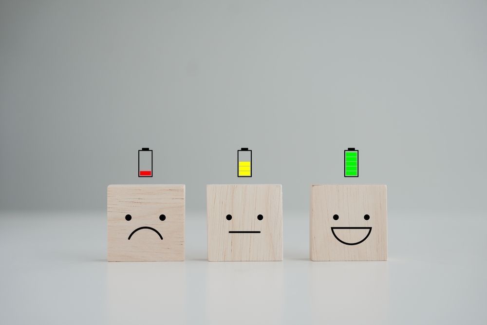 A row of wooden blocks with smiley faces on them.