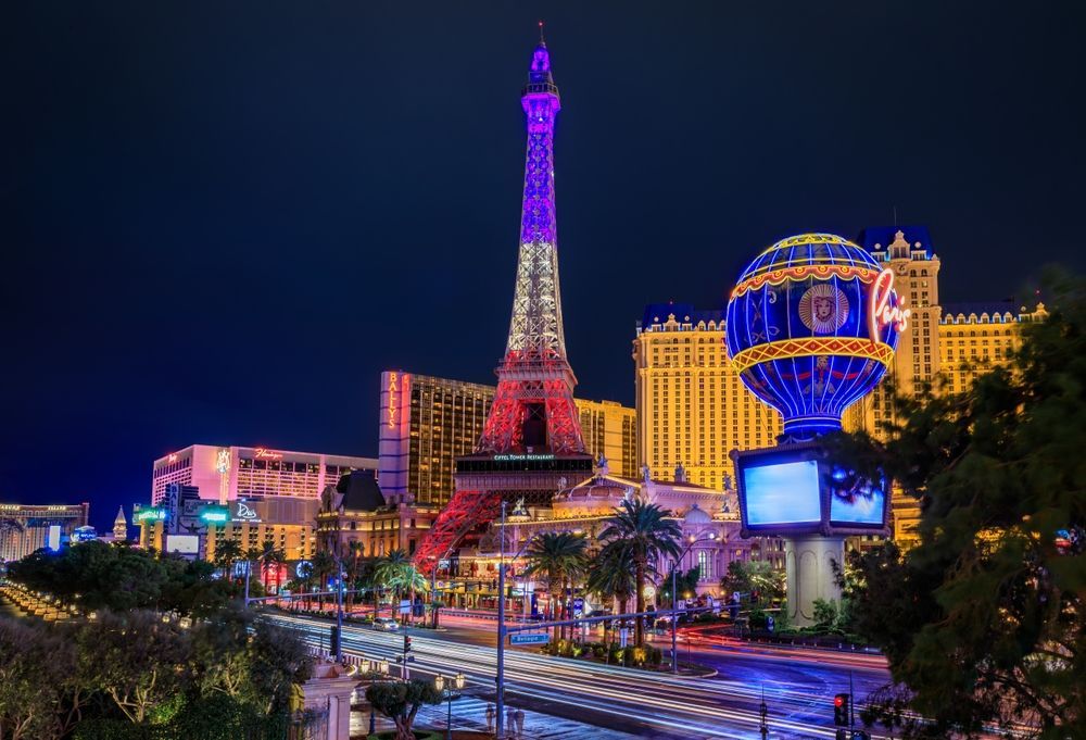 The eiffel tower is lit up at night in las vegas.