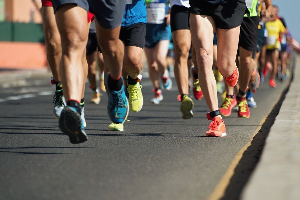 A group of people are running a marathon on a road.