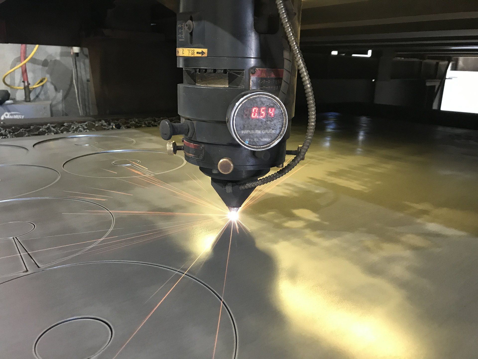 A machine is cutting a piece of metal with a laser.