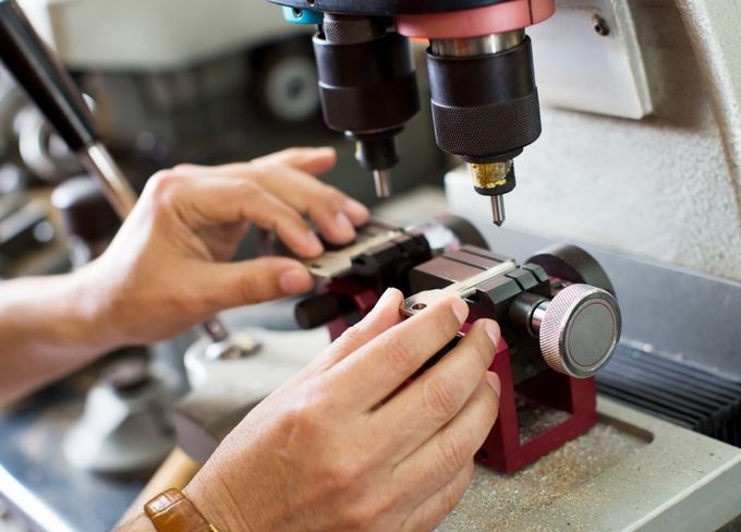 A person is using a machine to make a key.