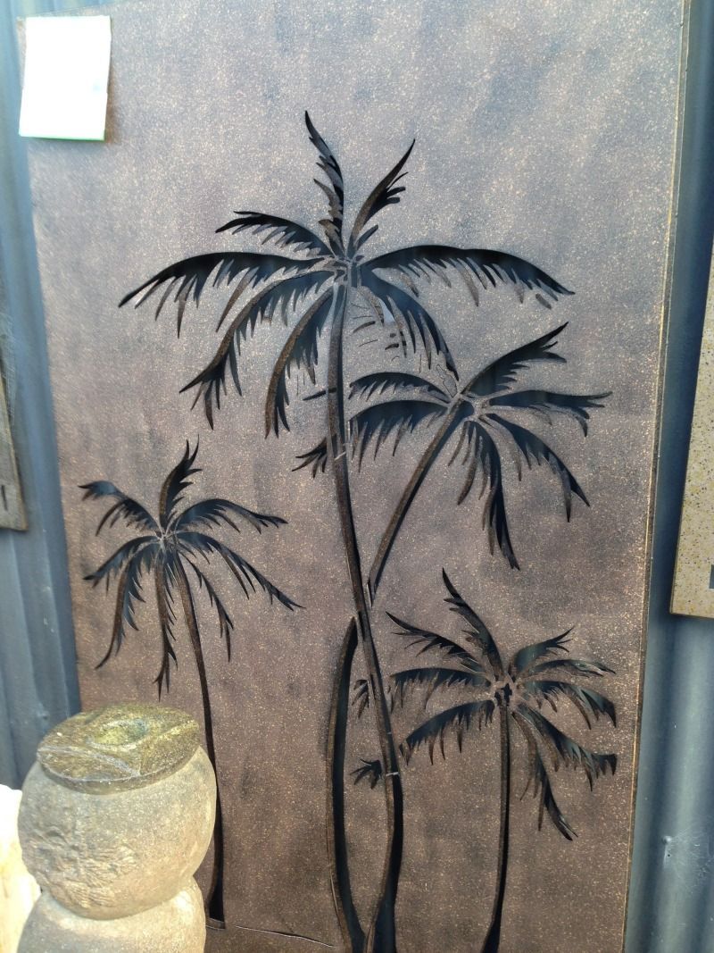 A painting of three palm trees on a wall.