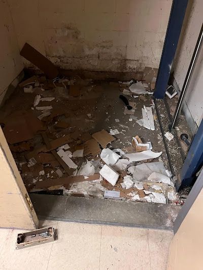A room with a lot of trash on the floor.