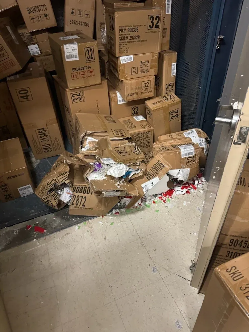 A bunch of boxes are stacked on top of each other in a room.