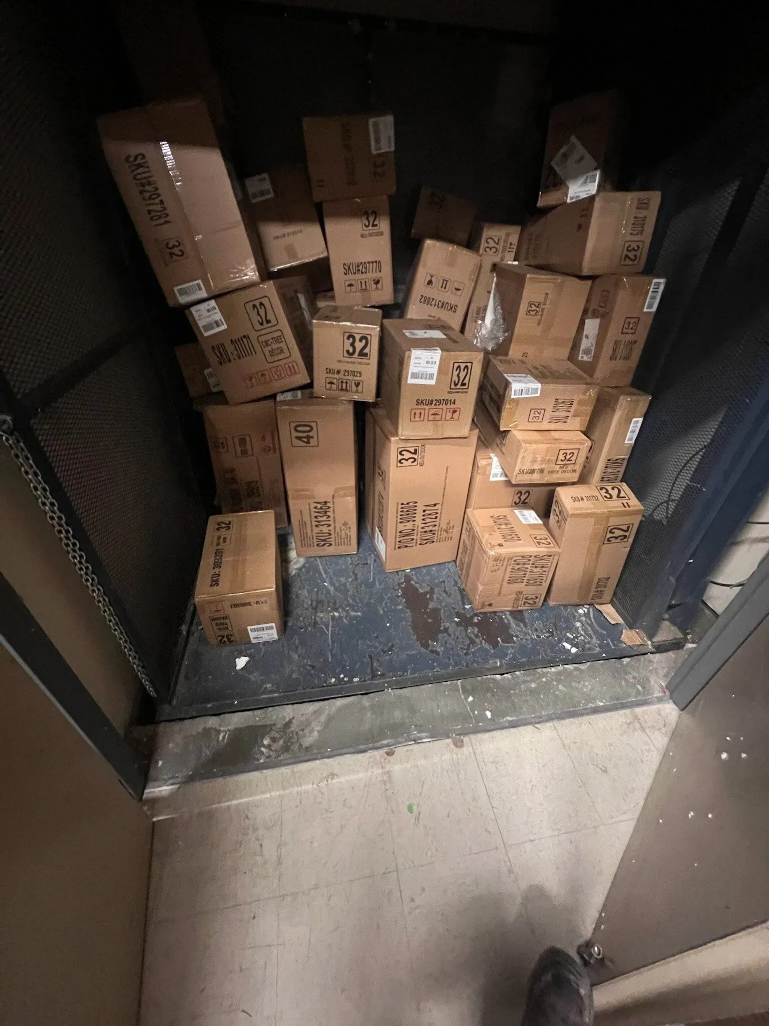 A bunch of boxes are stacked on top of each other in a room.