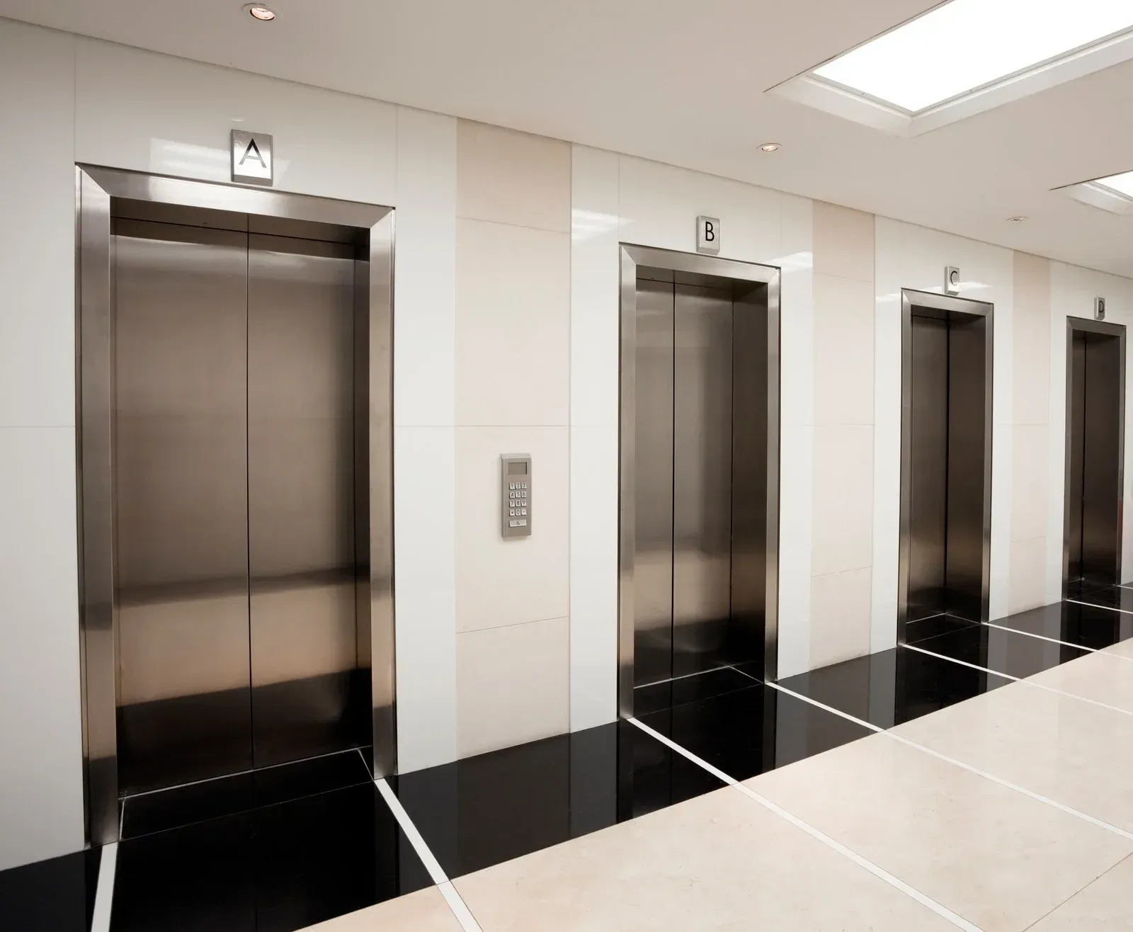 A row of elevators in a building with the doors open