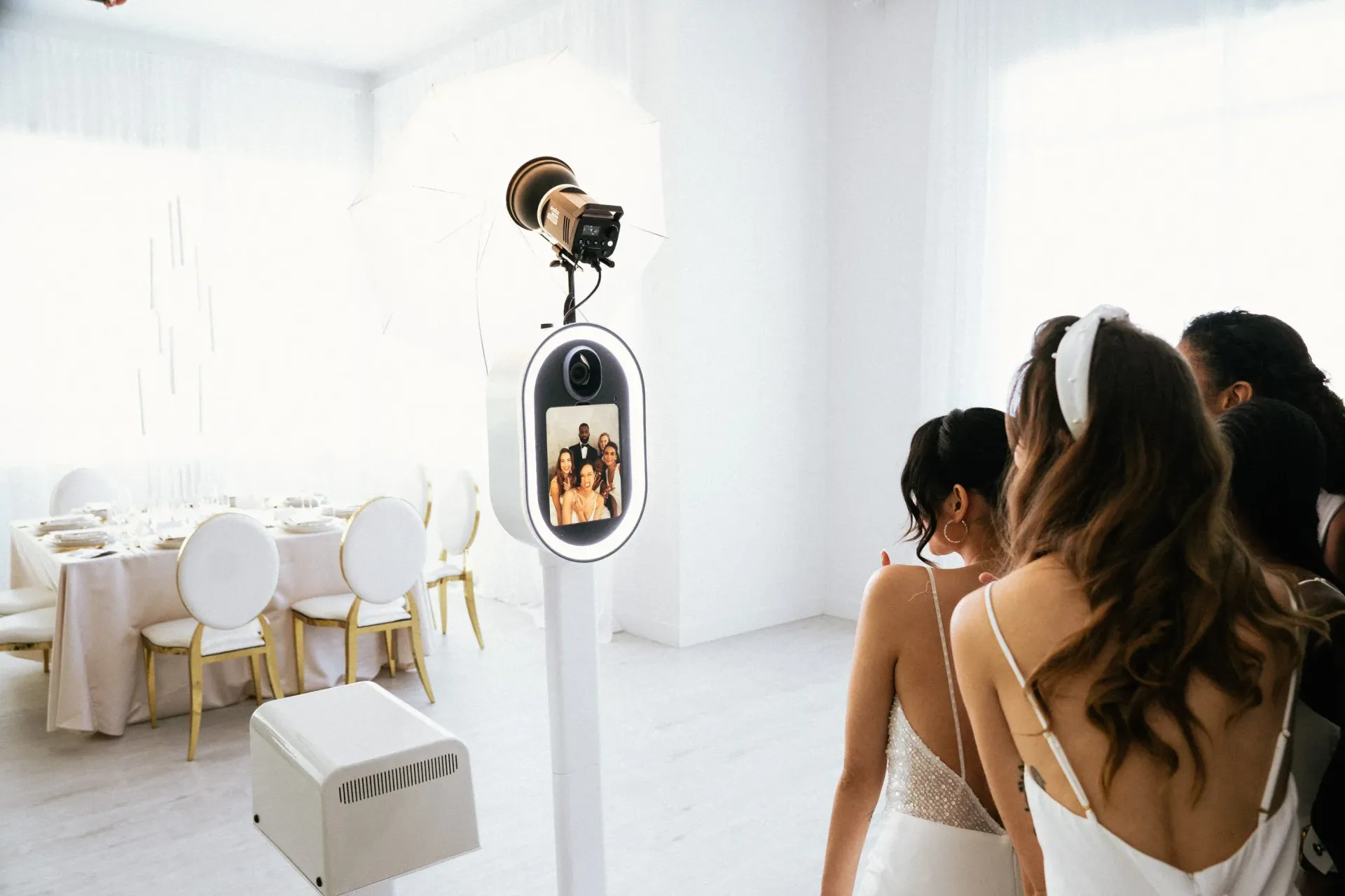 Modern open-air photo booth setup with gold accents at a luxury wedding event