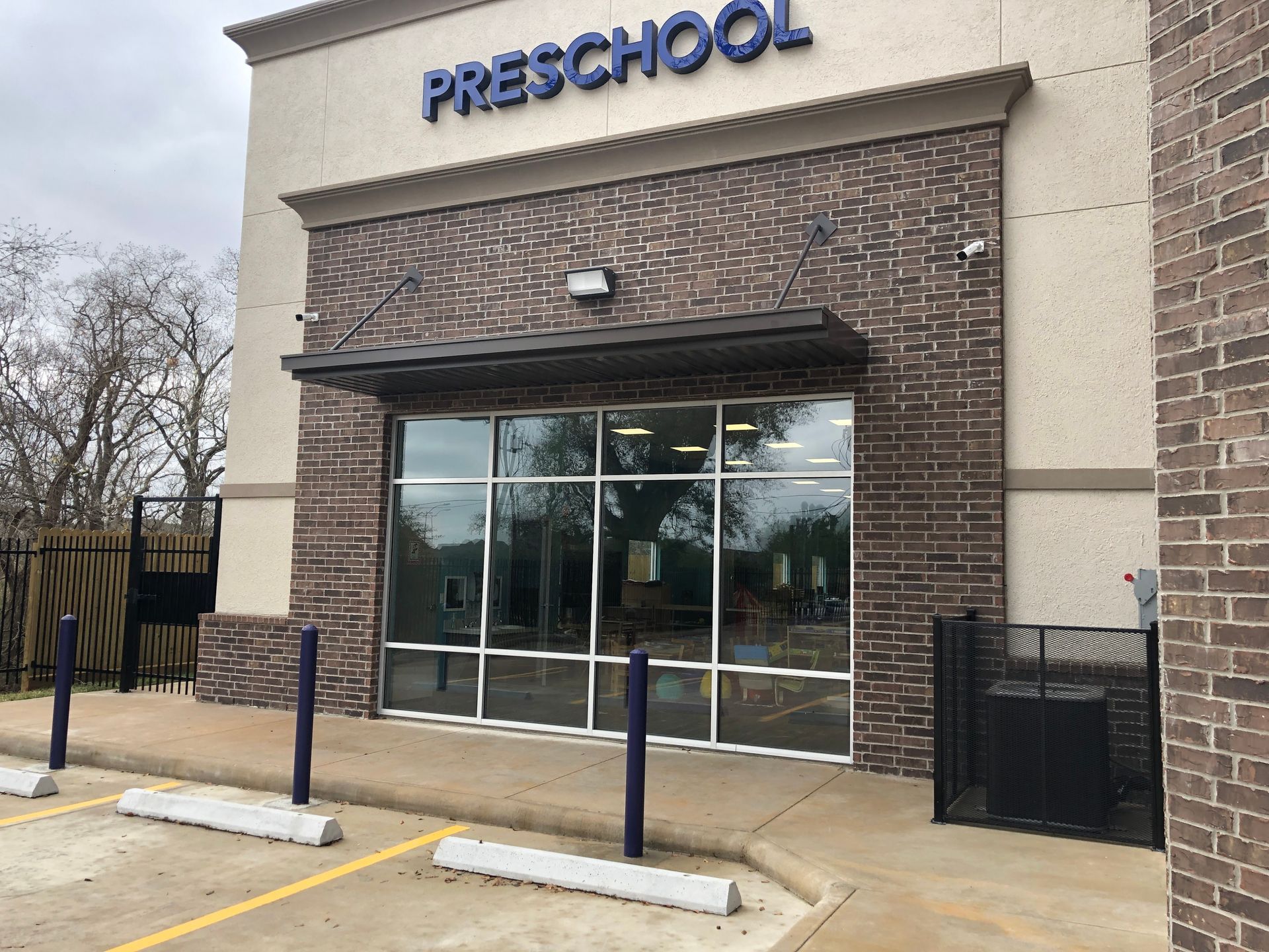 Preschool entrance with large windows, awning, and 