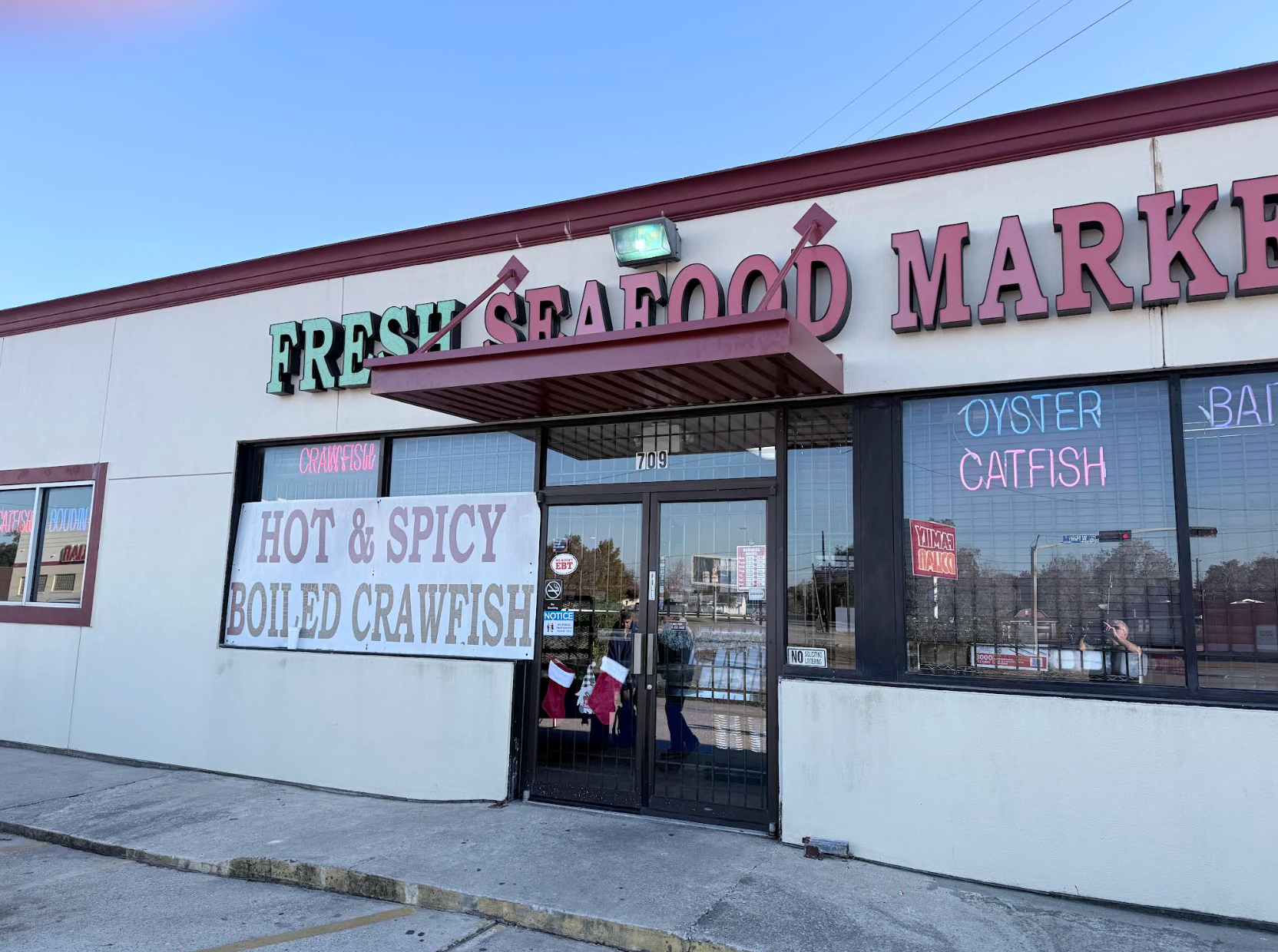 Patio with attached carport overlooking a pool area. Rose bush in foreground.