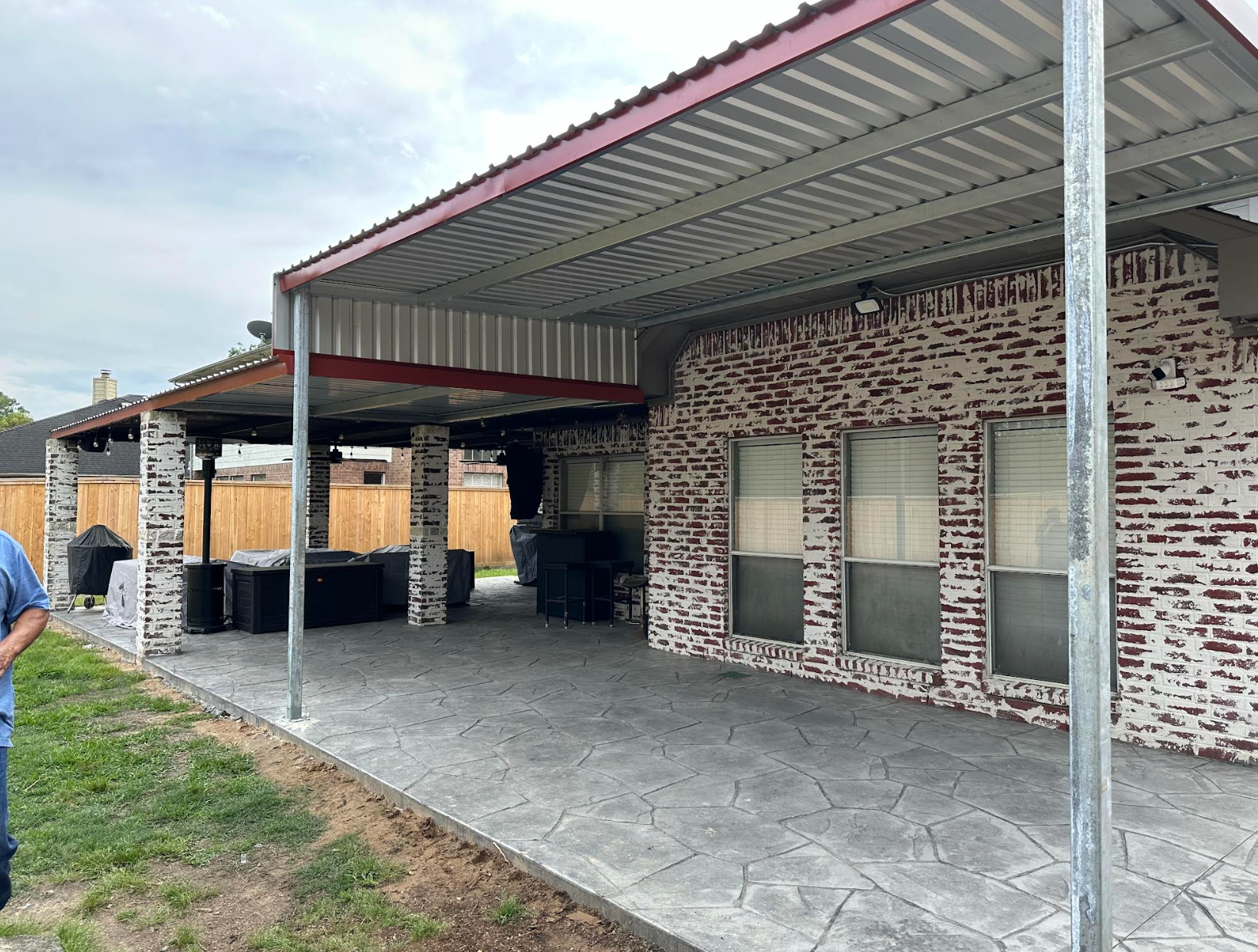 Outdoor gym with covered equipment, surrounded by fences and overcast sky.