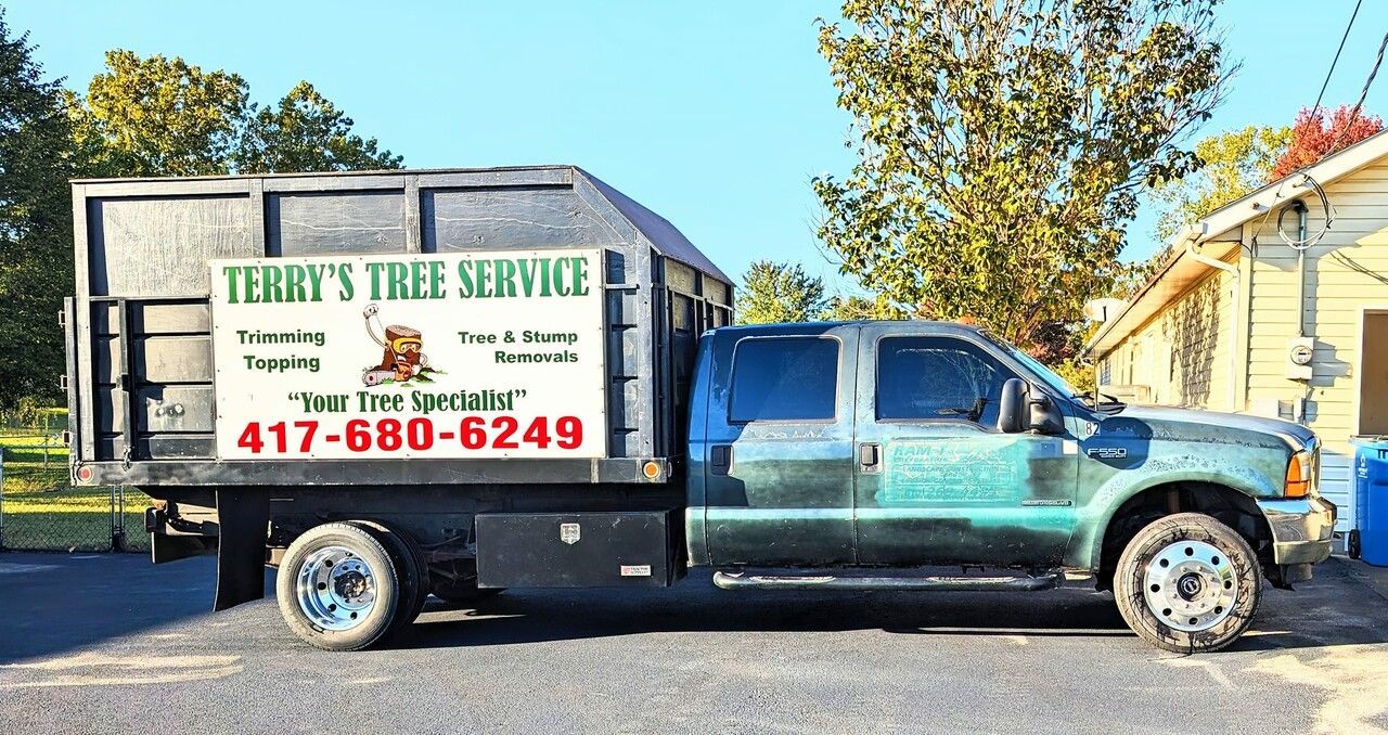 a terry 's tree service truck is parked in front of a house