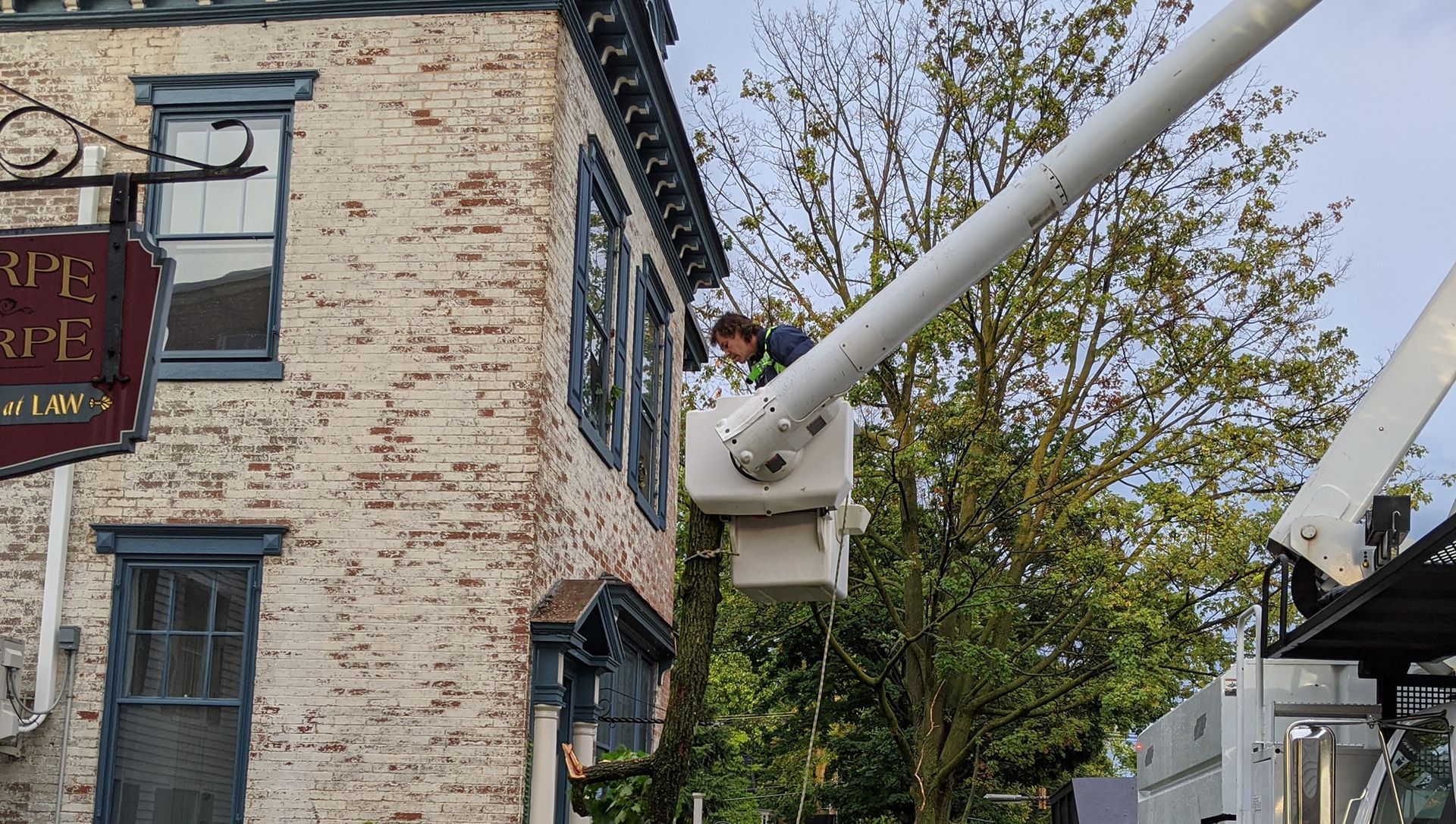 A man is working on a building with a crane.