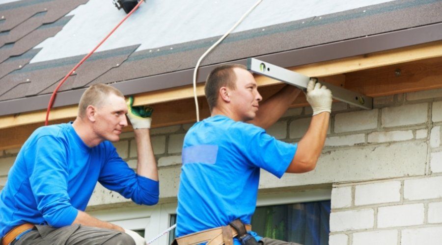 two roofers installing roof