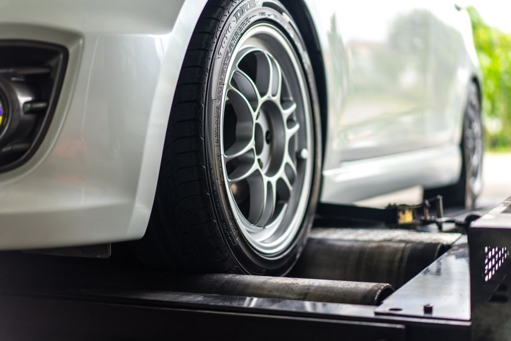 A White Car is Being Tested on a Machine — Forster Mechanical Repairs & Servicing In Forster, NSW