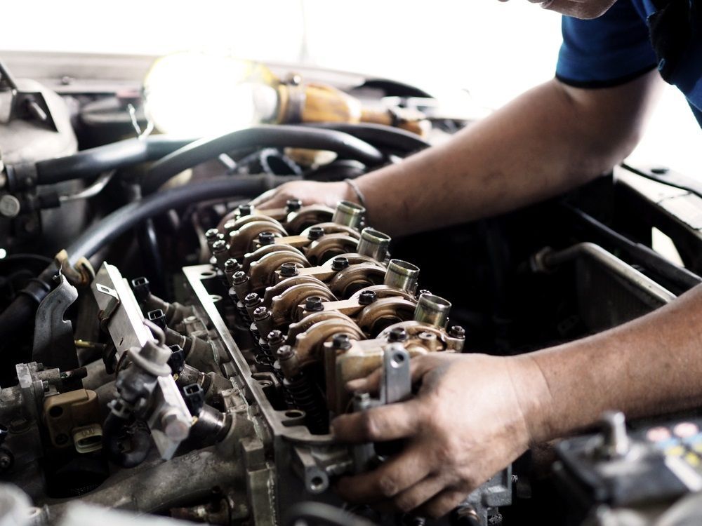 A Man is Working on the Engine of a Car — Forster Mechanical Repairs & Servicing In Forster, NSW