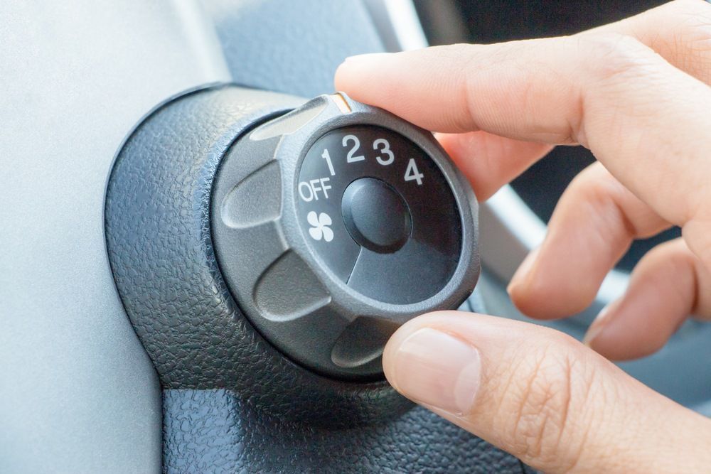 A Person is Adjusting the Air Conditioning in a Car — Forster Mechanical Repairs & Servicing In Forster, NSW