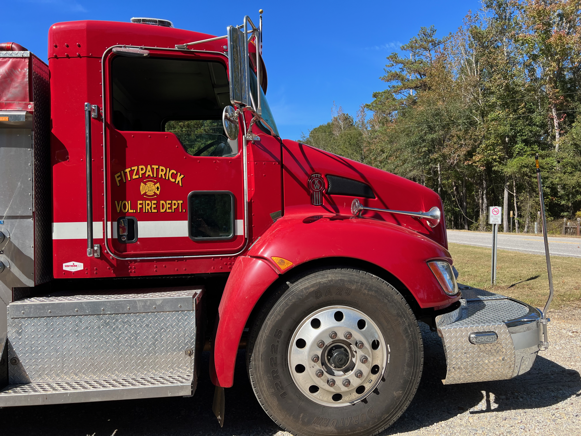 A red fire truck is parked on the side of the road